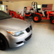 An American flag presiding over... nothing American. A Japanese tractor and a German sedan?!